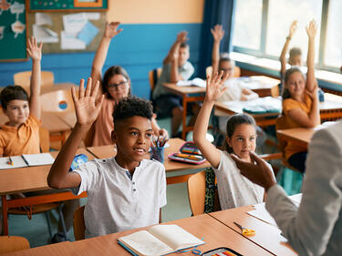 Preteens in a classroom engaged in learning