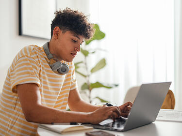 Teen boy working on his laptop